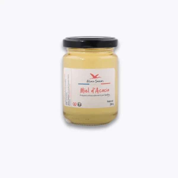 pot de miel d'acacia sur fond gris