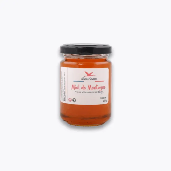 pot de miel de montagne sur fond gris