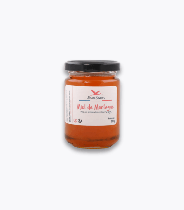 pot de miel de montagne sur fond gris